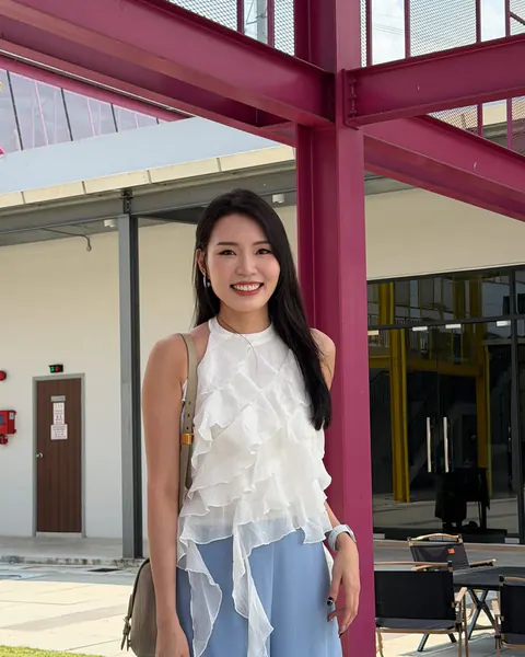 Creator wearing a white layered MUSII top outdoors